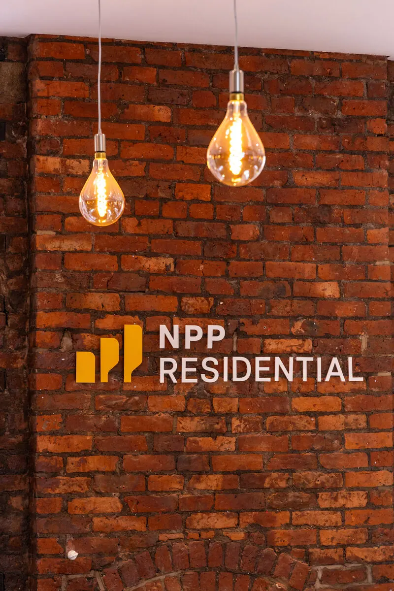 NPP Residential office signage on exposed brick wall